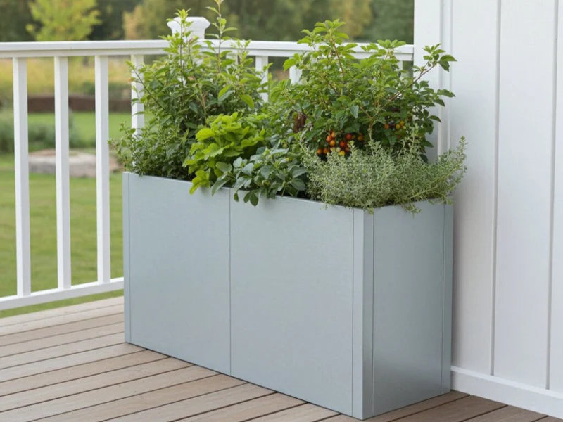 CUBY rektangulær plantekasse i galvanisert stål med frodige planter på terrasse