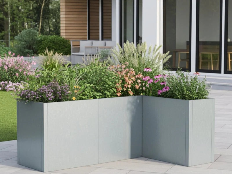 Vinkel plantekasse i galvanisert stål fra CUBY med blomstrende planter