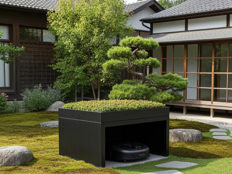 Robotgressklipper garasje i svartlakkert stål i minimalistisk hage