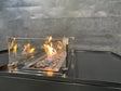 Vindskjerm i glass for gassbrenner